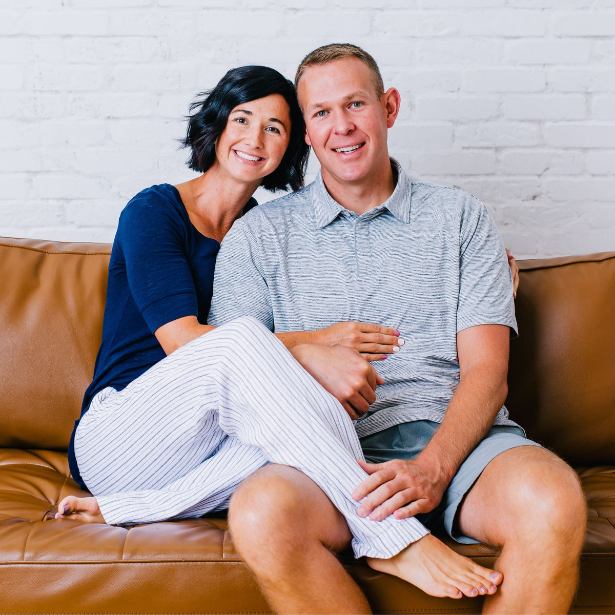 evree co-founders Natalie and Justin sitting together on a leather sofa